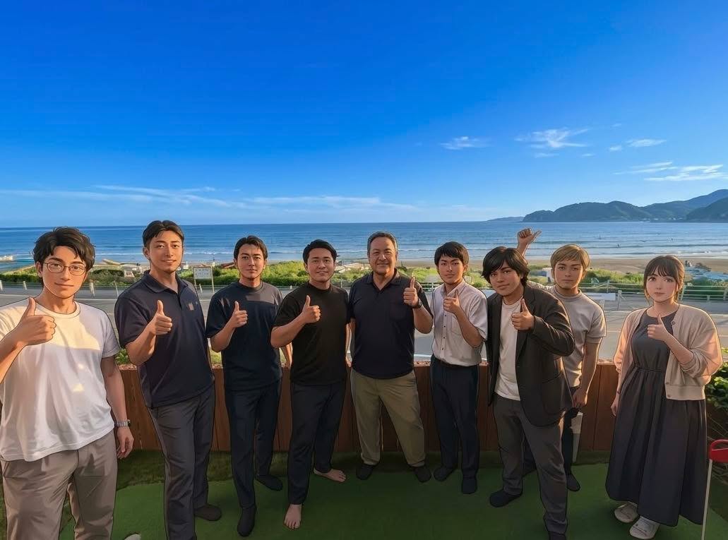 海と青空を背に、体験セッションの参加者9人が並んで親指を立てている集合写真